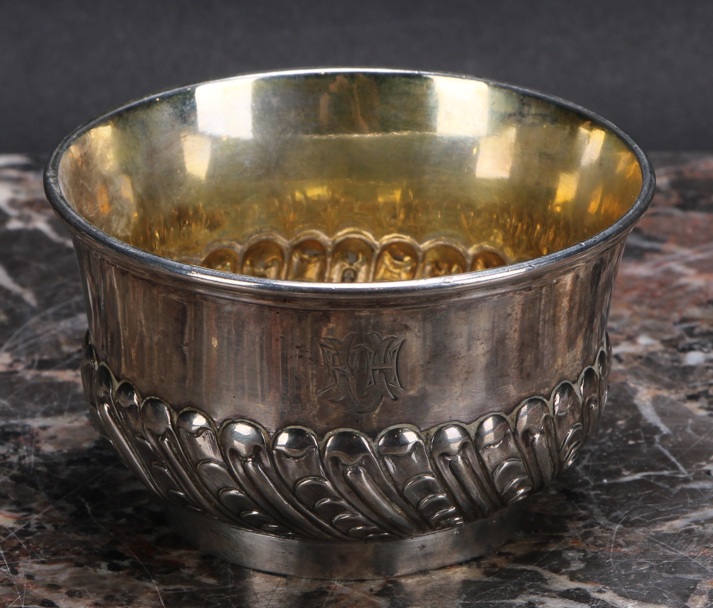 An 18th/19th century silver half-fluted bowl, gilt interior, 9.5cm diam, struckj three times with