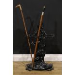 A cast iron walking stick or umbrella stand, cast in the manner of Coalbrookdale as a dog beneath