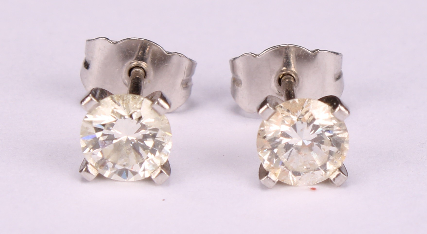 A pair of diamond stud earrings, the round brilliant cut stones claw set, platinum mounted, 1.7ct - Image 2 of 5