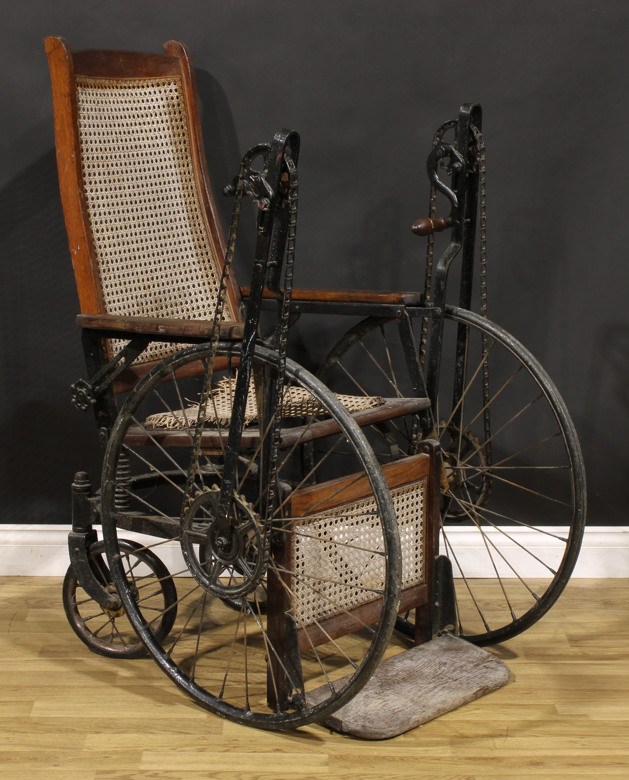 An early to mid-20th century American oak hand-crank wheelchair, by Gendron Wheel Company,