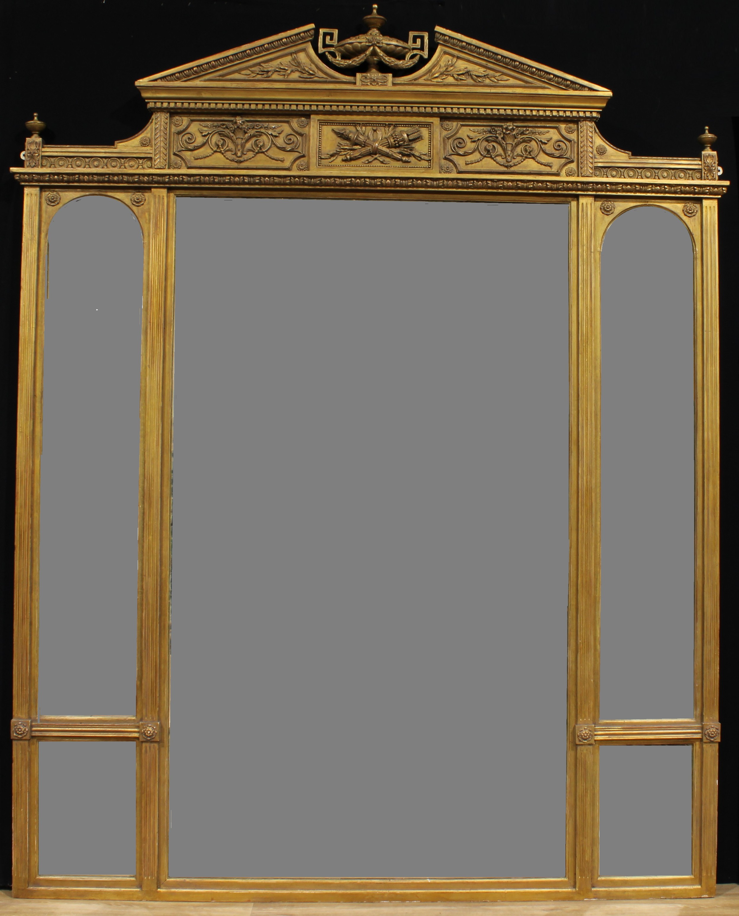 A substantial Louis XVI Revival giltwood and gesso salle de bal looking glass, broken-arch