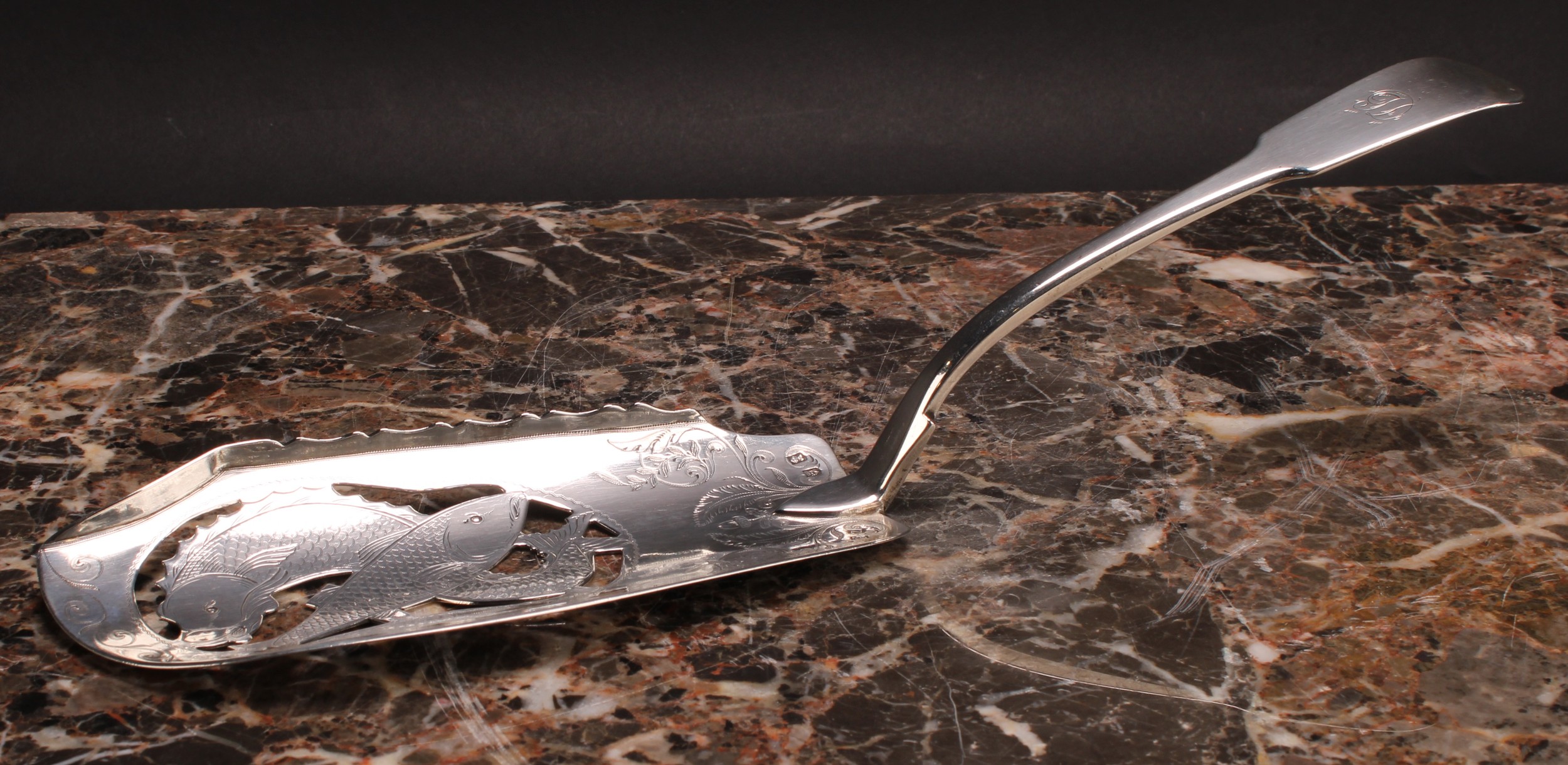 A George III Irish silver Fiddle pattern fish slice, pierced and bright-cut engraved with fish and