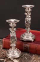 A pair of sculptural silver plated table candlesticks, cast in the Renaissance Revival taste with