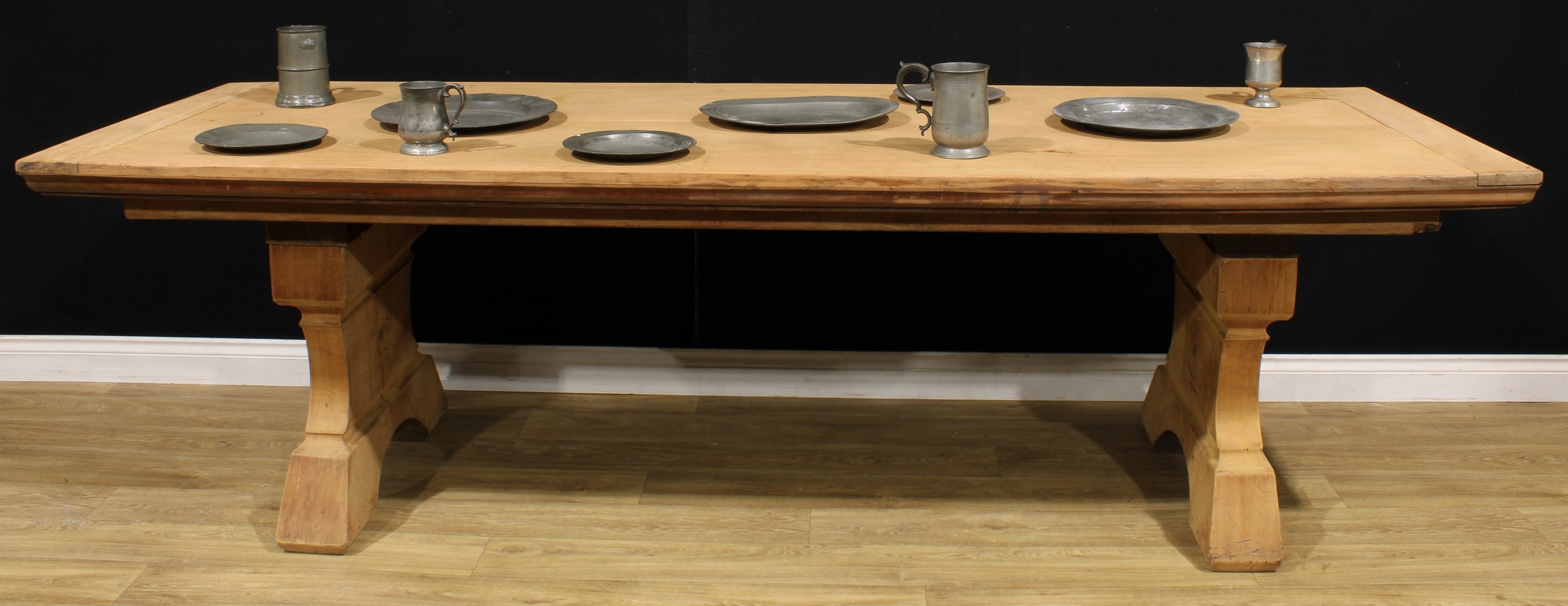 An early 20th century French Provincial walnut monastery refectory table, rectangular top, shaped