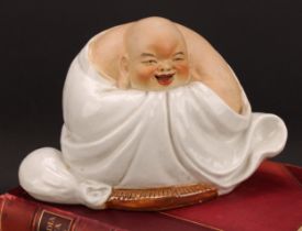 A Chinese pottery figure, of Budai, seated, 19cm high