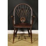 An Arts & Crafts period oak Windsor elbow chair, hoop back with nine spindles radiating from a