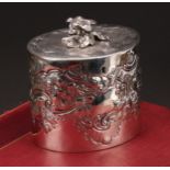 A George III oval tea caddy, chased with birds, flowers and scrolling leaves, flush-hinged cover