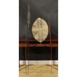 A Maasai spear, 174cm long, Kenya, 19th century; others; a Zulu hide shield, 60cm long, South