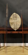 A Maasai spear, 174cm long, Kenya, 19th century; others; a Zulu hide shield, 60cm long, South