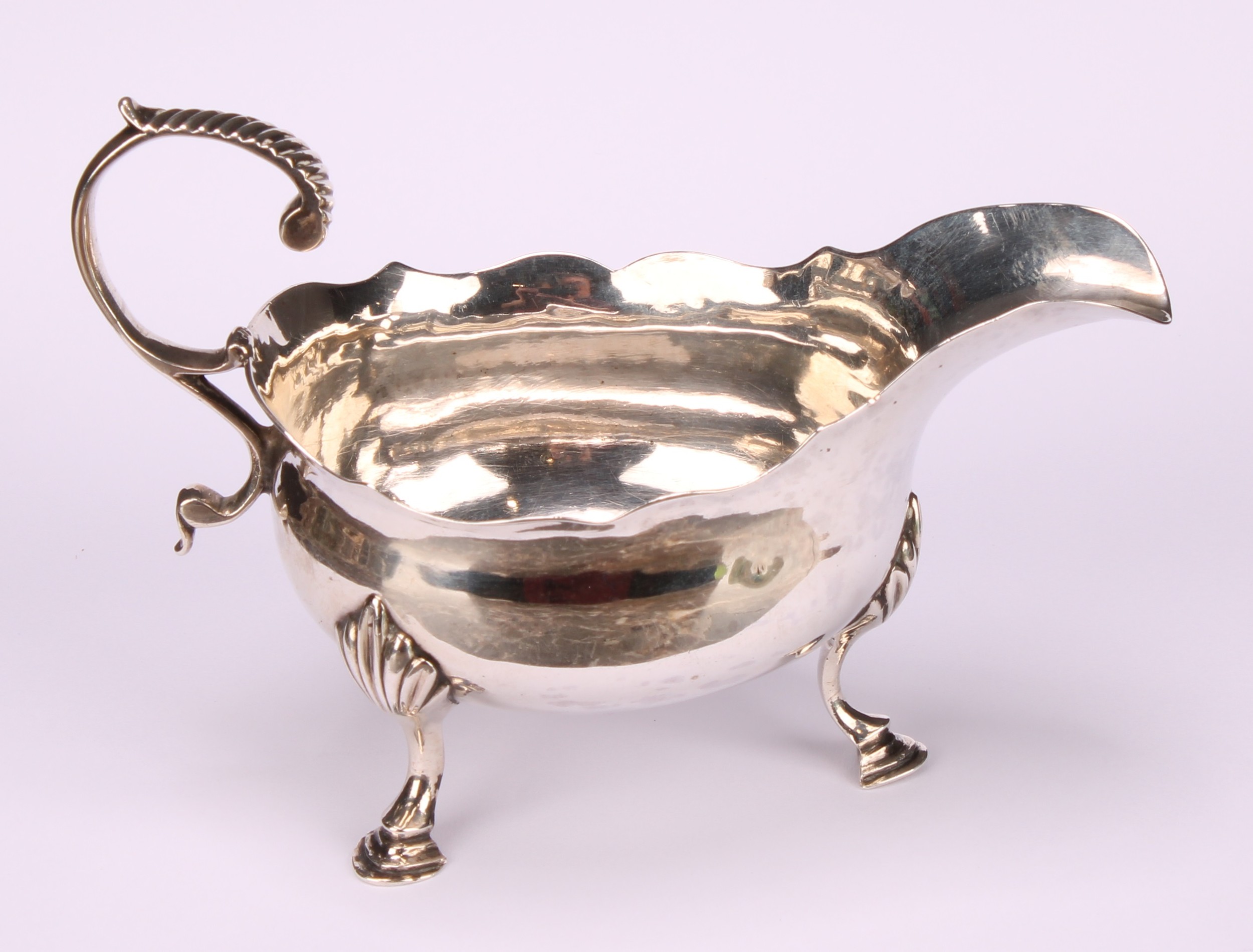 A George III silver sauce boat, acanthus-capped flying scroll handle, wavy rim, hoof feet, 13cm - Image 2 of 5