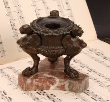 A 19th century brown patinated bronze tripod inkwell, cast in the Grand Tour taste with winged