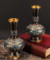 A pair of Chinese cloisonne enamel ovoid pedestal vases, brightly decorated in polychrome with