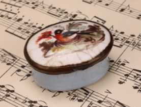 A George III South Staffordshire enamel oval patch box, hinged cover painted with a bird, pale