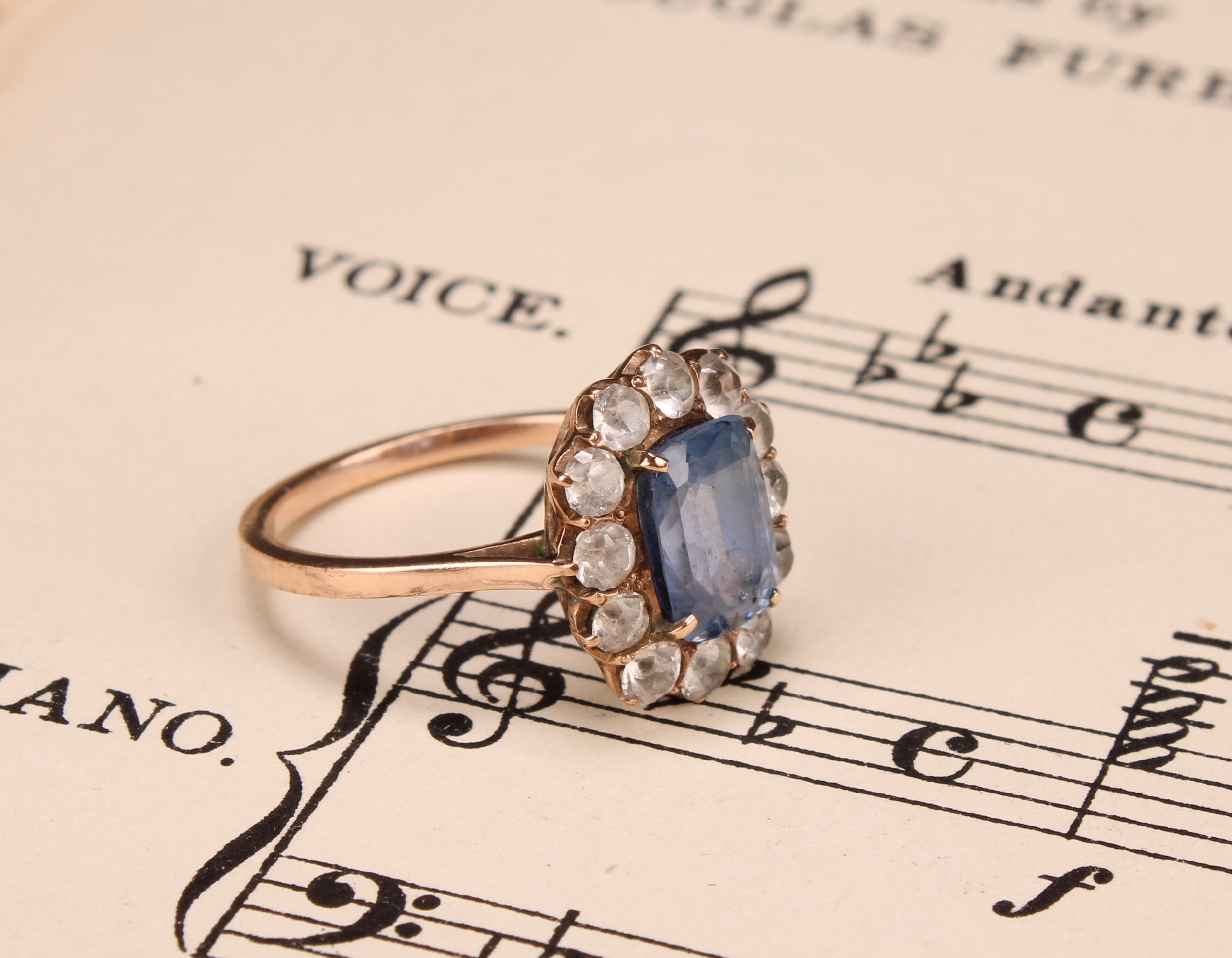 A 19th century pale blue and white sapphire effect paste cluster ring, central cushion cut pale blue