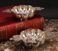 A pair of Dutch silver brandy bowls, of typical lobed design, pierced lug handles, 20.5cm wide, late