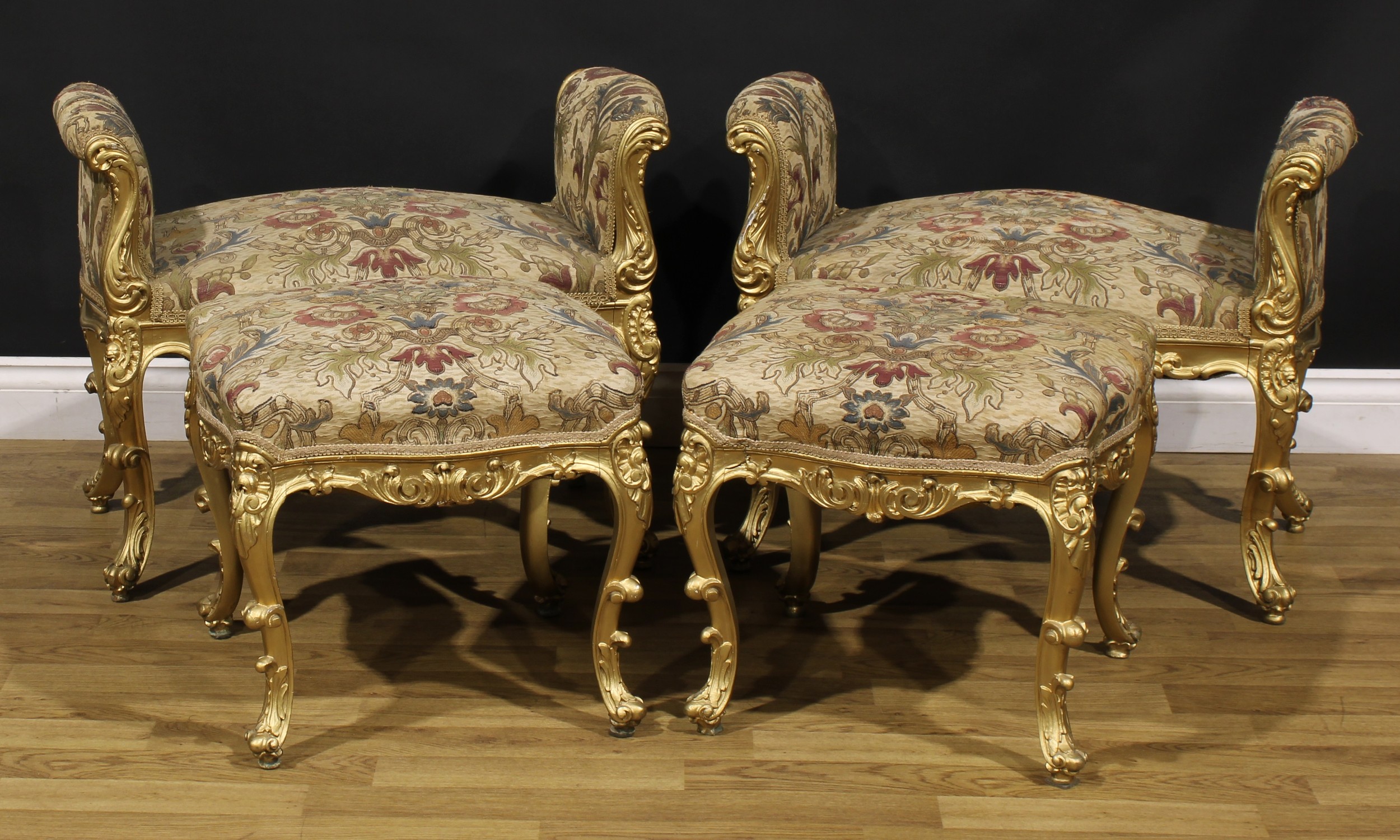 A Italian Rococo Revival giltwood drawing room suite, comprising a pair of window seats and a pair