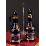 A 19th century Belgian silver two-bottle oil and vinegar cruet, gilded blue glass decanters and