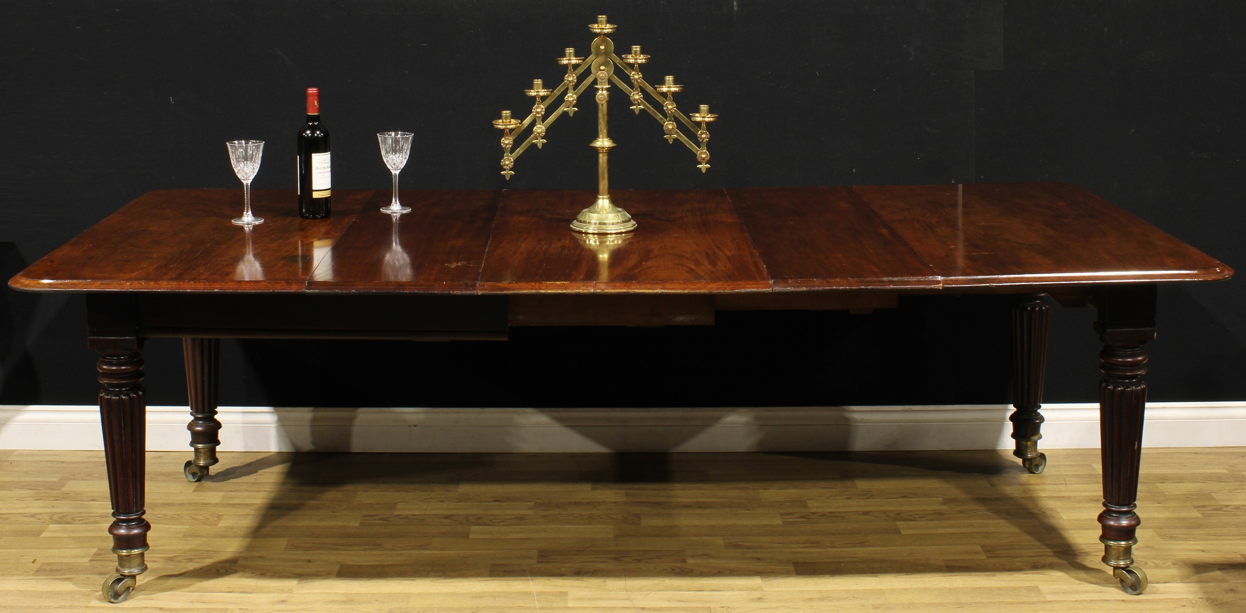 A 19th century mahogany extending dining table, in the manner of Gillows of Lancaster and London,