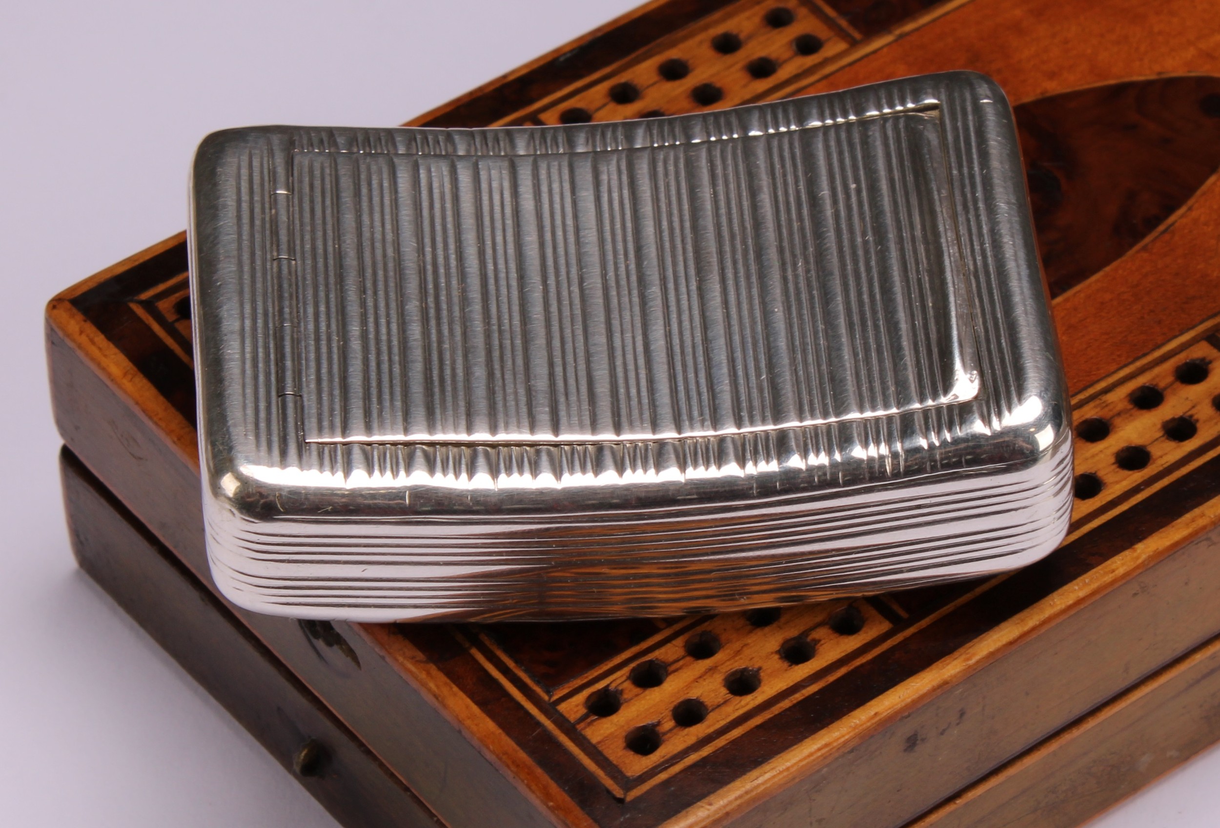 A George III silver curved rounded rectangular snuff box, reeded overall, flush-hinged cover, gilt