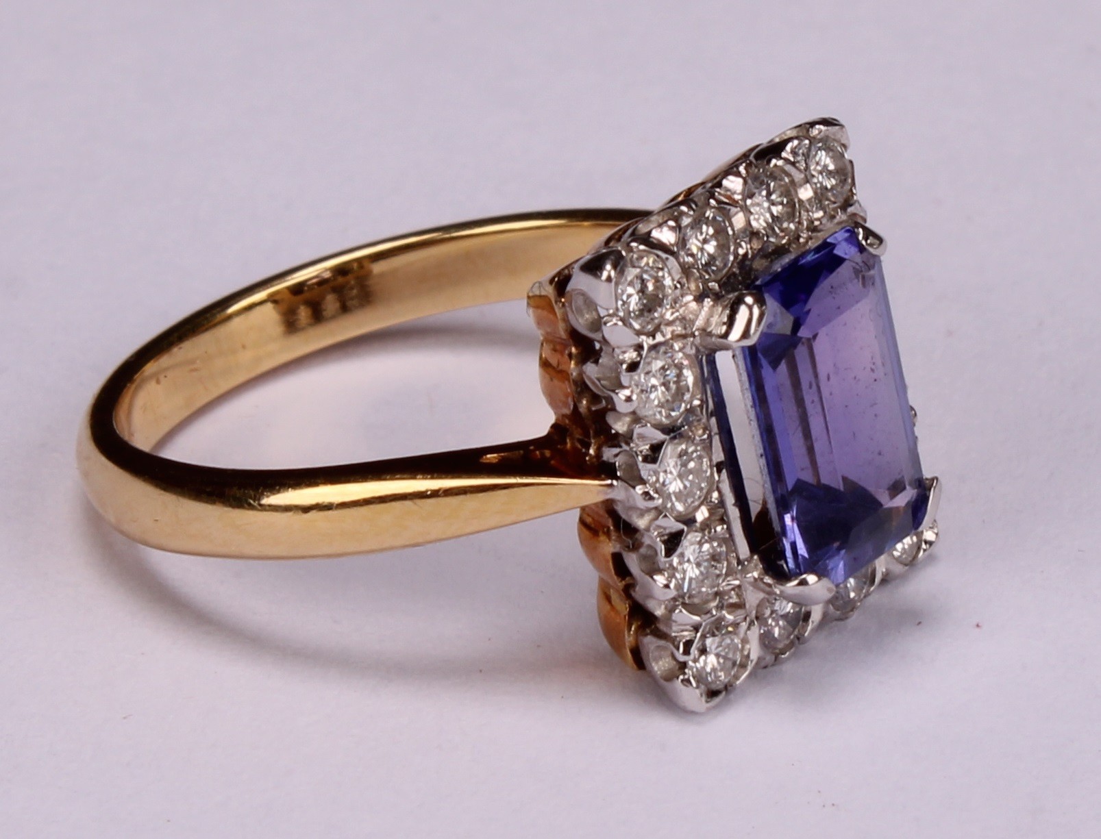 A tanzanite and diamond ring, the rectangular cushion cut stone claw set within a single band of - Image 2 of 5
