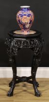 A Chinese hardwood jardiniere stand, octagonal top with beaded border and inset marble panel, shaped