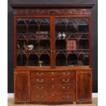 A 19th century Adam Revival mahogany library bookcase, outswept cornice above a deep frieze carved