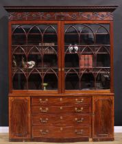 A 19th century Adam Revival mahogany library bookcase, outswept cornice above a deep frieze carved