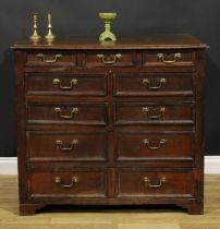 An early 18th century oak chest, rectangular top with moulded edge above three small, four short and