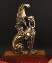 A 19th century parcel-silvered model, cast as a winged lion, 31cm high, hardwood plinth, 35cm high