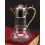 A Victorian silver mounted clear glass trumpet shaped claret jug, hinged cover, star-cut base,