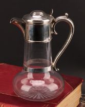 A Victorian silver mounted clear glass trumpet shaped claret jug, hinged cover, star-cut base,