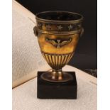 A French silver gilt vase, in the Empire taste, applied with masks and neoclassical motifs, black