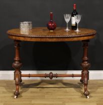 A Victorian Irish walnut and marquetry stretcher table, oval top with carved edge, turned supports