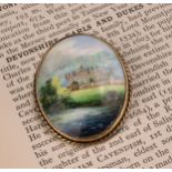 A Lynton oval brooch, painted by Stefan Nowacki, signed, Chatsworth House, silver gilt mount,