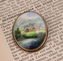 A Lynton oval brooch, painted by Stefan Nowacki, signed, Chatsworth House, silver gilt mount,