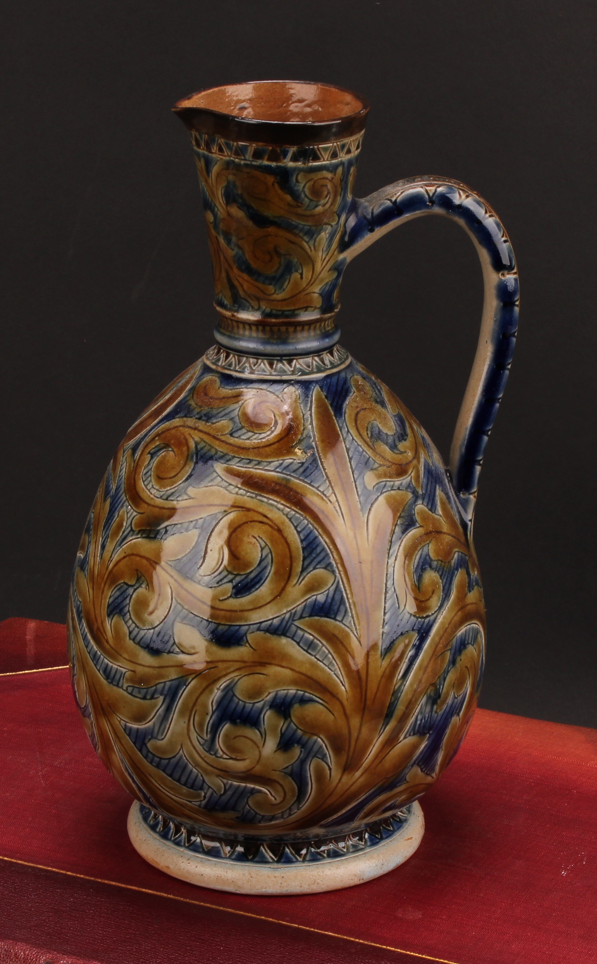 A Doulton Lambeth earthenware ovoid ewer, by Arthur B Barlow, sgraffito incised with stiff and