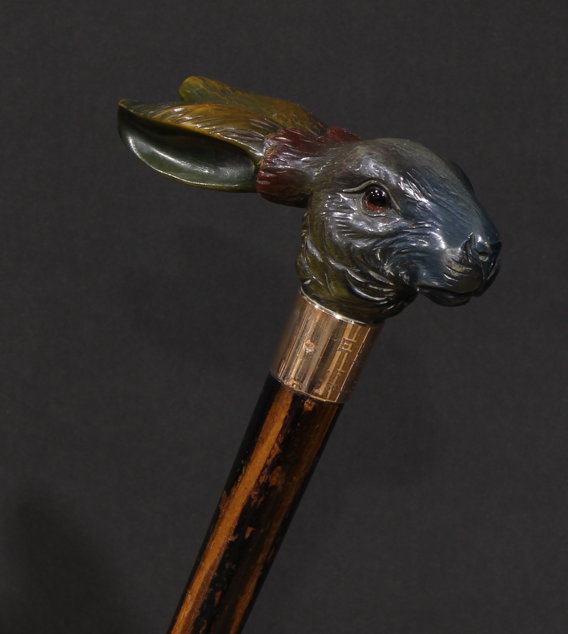 An early 20th century novelty walking stick, the handle finely carved as the head of a hare, gilt