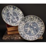 A pair of 17th century Chinese shipwreck porcelain dishes, painted in tones of underglaze blue