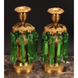 A pair of 19th century dark patinated and gilt metal mantel candle lustres, campana sconces, green