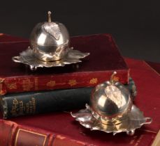 A pair of Elizabeth II silver novelty condiments and stands, modelled as apples, the cast leaf