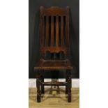 A William & Mary oak side chair, shaped cresting rail, panel seat, turned and blocked forelegs,