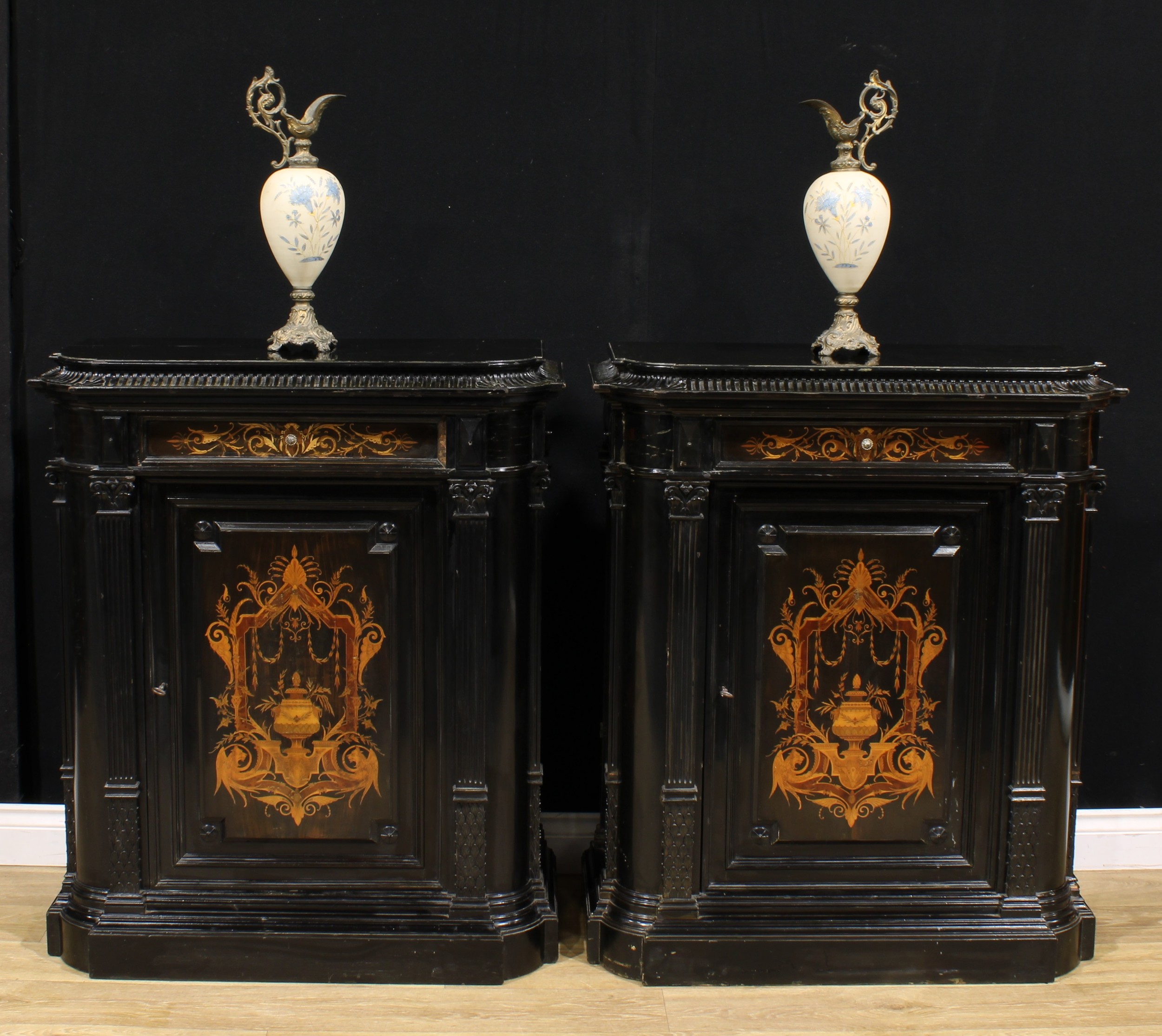 A pair of 19th century Continental ebonised and marquetry pier cabinets, each with a concave moulded
