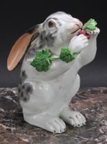 A Continental porcelain model, of a rabbit, on hind legs eating grapes from a vine, 15.5cm high, c.