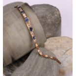 A rose metal mounted bluie and white sapphire articulated bracelet, set with five graduated blue