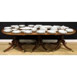 A Post-Regency mahogany triple-pillar dining table, each tilting top crossbanded with satinwood