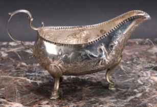 An 18th century Irish silver sauce boat, chased with figures fishing, acanthus-capped double