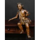 A Baroque polychrome painted softwood and gesso carving, of a scantily clad putto, 65cm high, c.