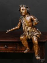 A Baroque polychrome painted softwood and gesso carving, of a scantily clad putto, 65cm high, c.