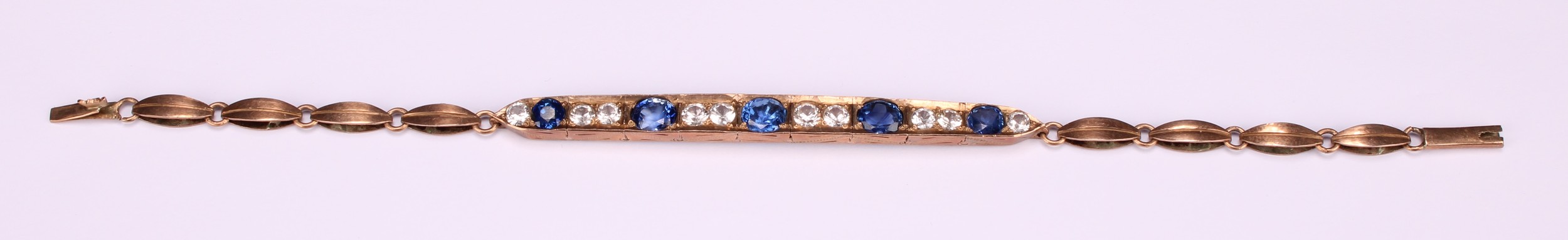 A rose metal mounted bluie and white sapphire articulated bracelet, set with five graduated blue - Image 2 of 5