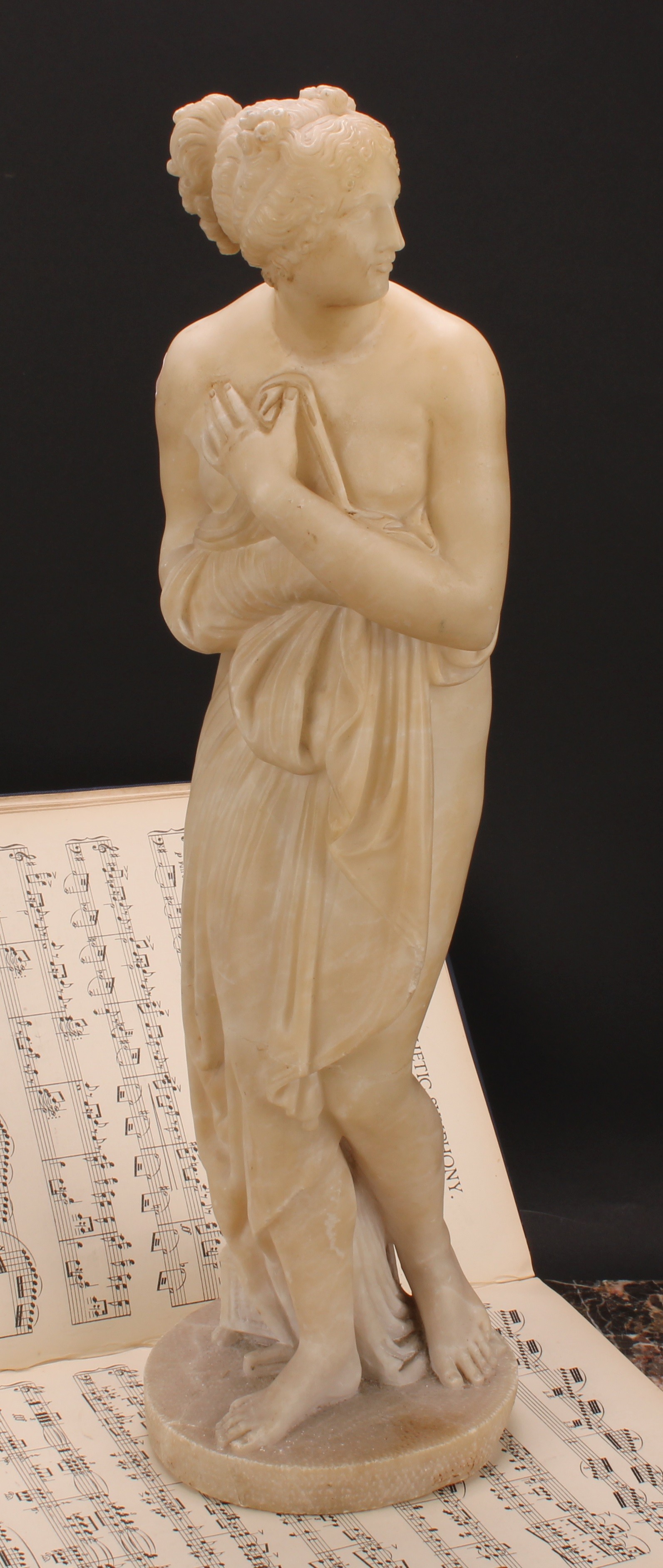 A 19th century alabaster figure, Venus Bathing, after the Antique, circular base, 53cm high